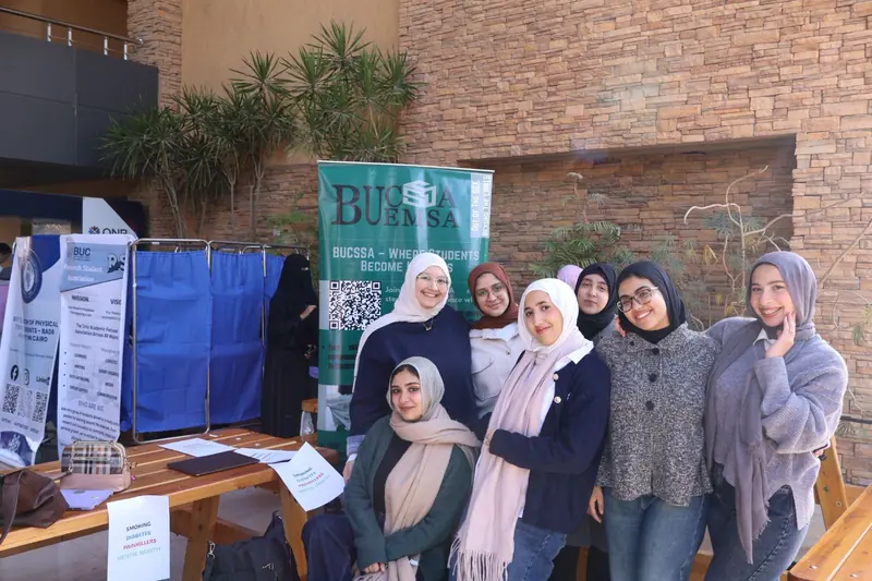 EMSA-BUC members at the screening station beside the BUCSA banner and privacy screens