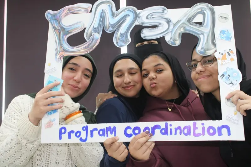 Four participants smile inside the EMSA "Program coordination" photo frame