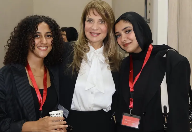 Two student organizers with the College's vice dean at the THPMR conference